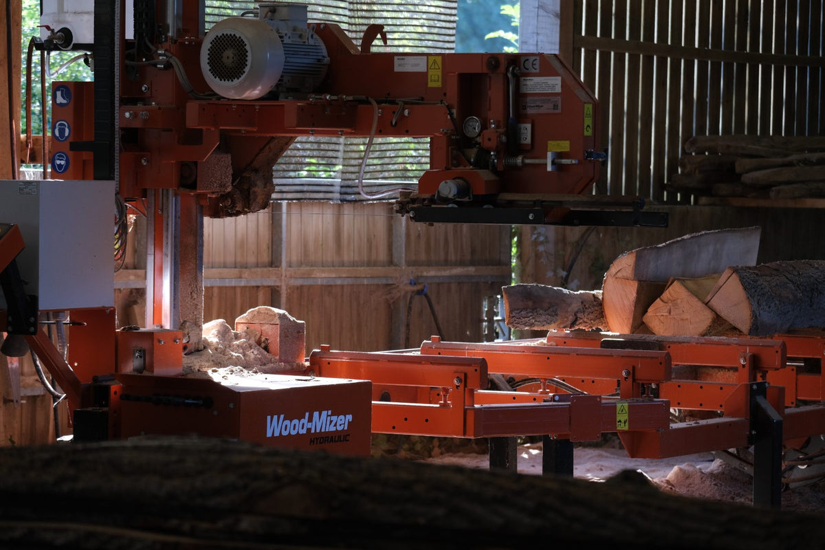 The sawmill in the barn, with ash logs on the bed